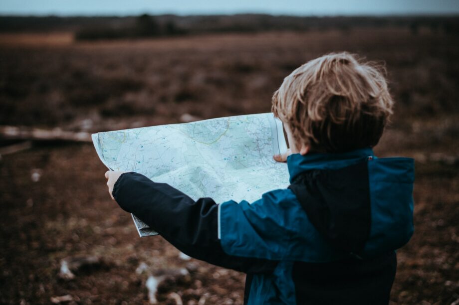 child holding a map